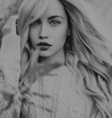 Black and white photo of a woman with long hair, featuring noticeable hair extensions enhancing her hairstyle.